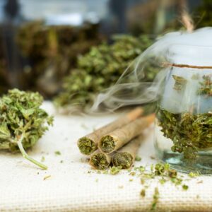Pre-Rolled cones for smoking cannabis with cannabis indica in a clear bottle